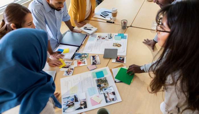 People standing around table