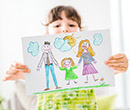 Child holding a crayon drawing